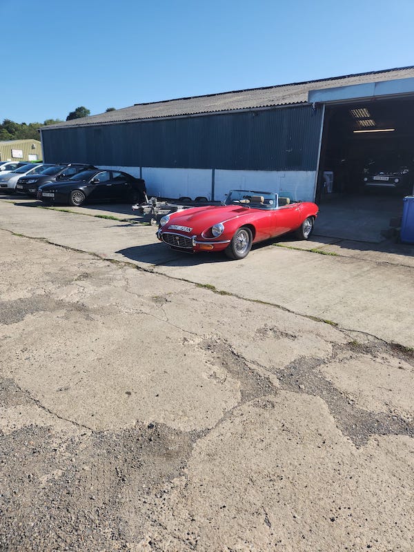 from a distance - red jaguar e-type s3 - Fostering Classics