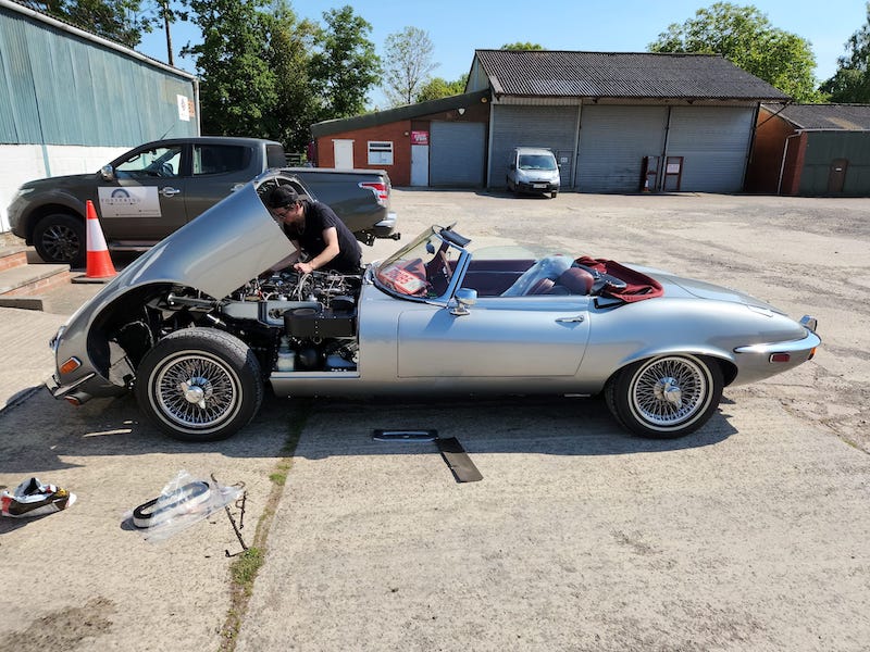 working on the engine in the sun - silver jaguar e-type s3 - Fostering Classics