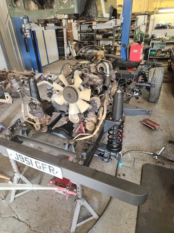 Land Rover Defender 90 - engine and gearbox going into the new chassis - Fostering Classics